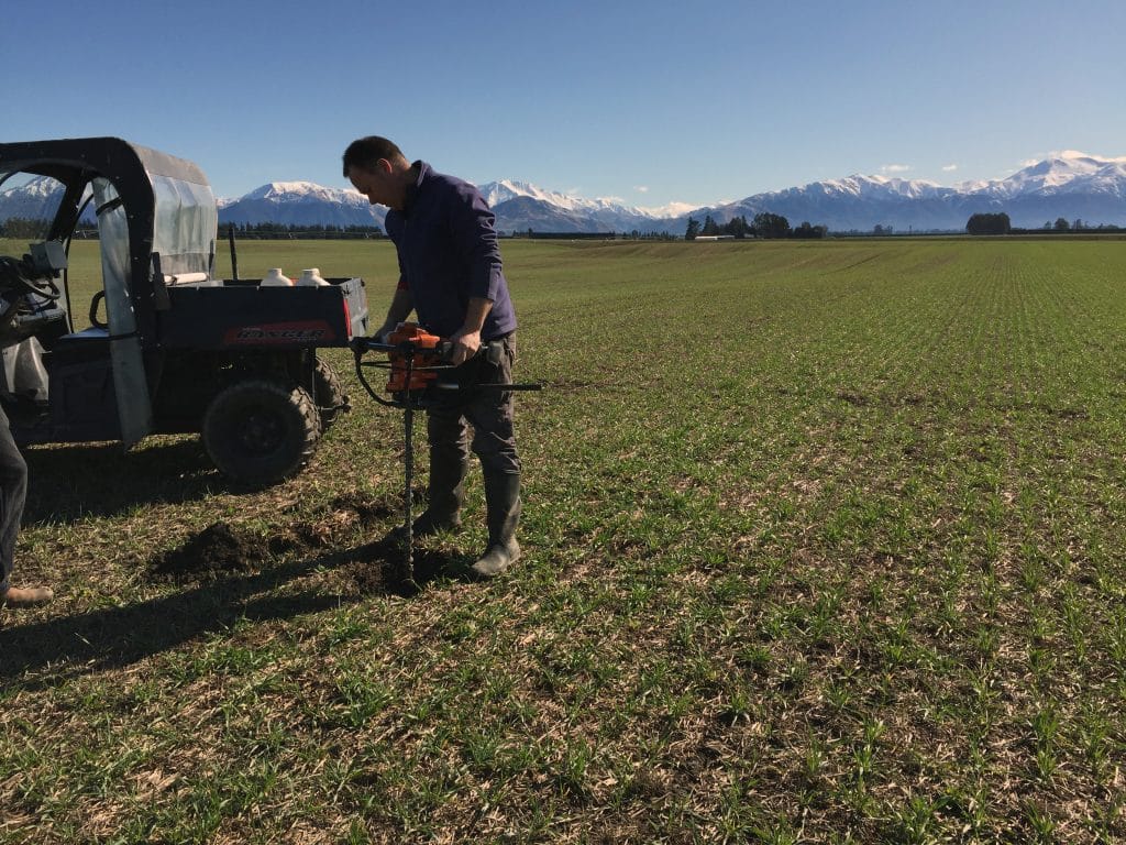 photo of NZ farm performing soil moisture check