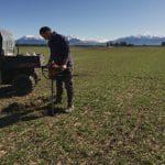 photo of NZ farm performing soil moisture check